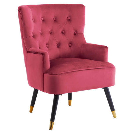 Velvet accent chair with tufted backrest, pink upholstery and black legs with gold tips