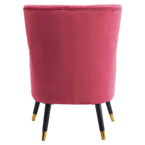 Back view of pink velvet accent chair with black legs and gold tips