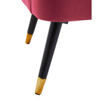 Close-up of pink chair with black and gold metal legs, modern furniture detail