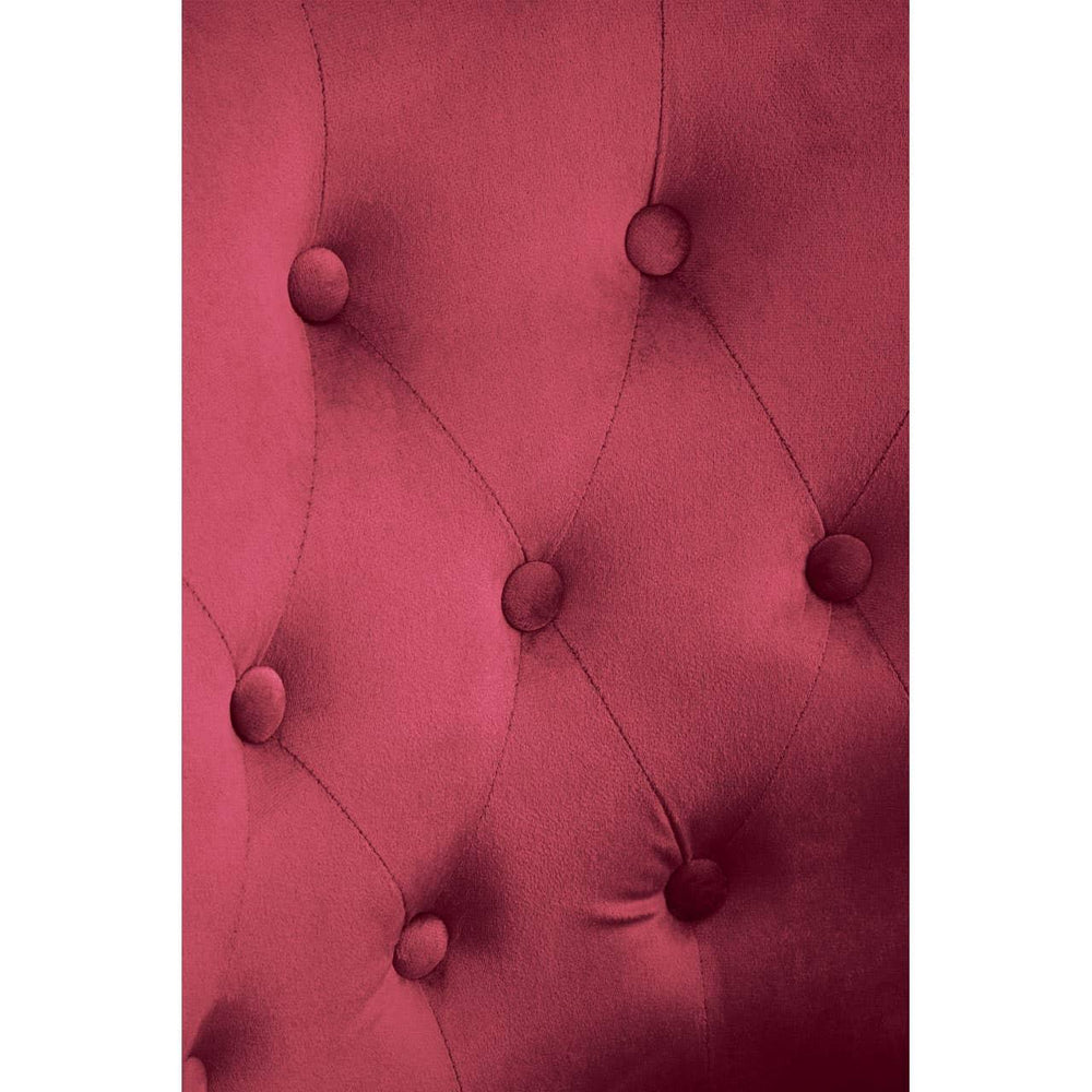 Red velvet upholstered headboard detail with deep button tufting