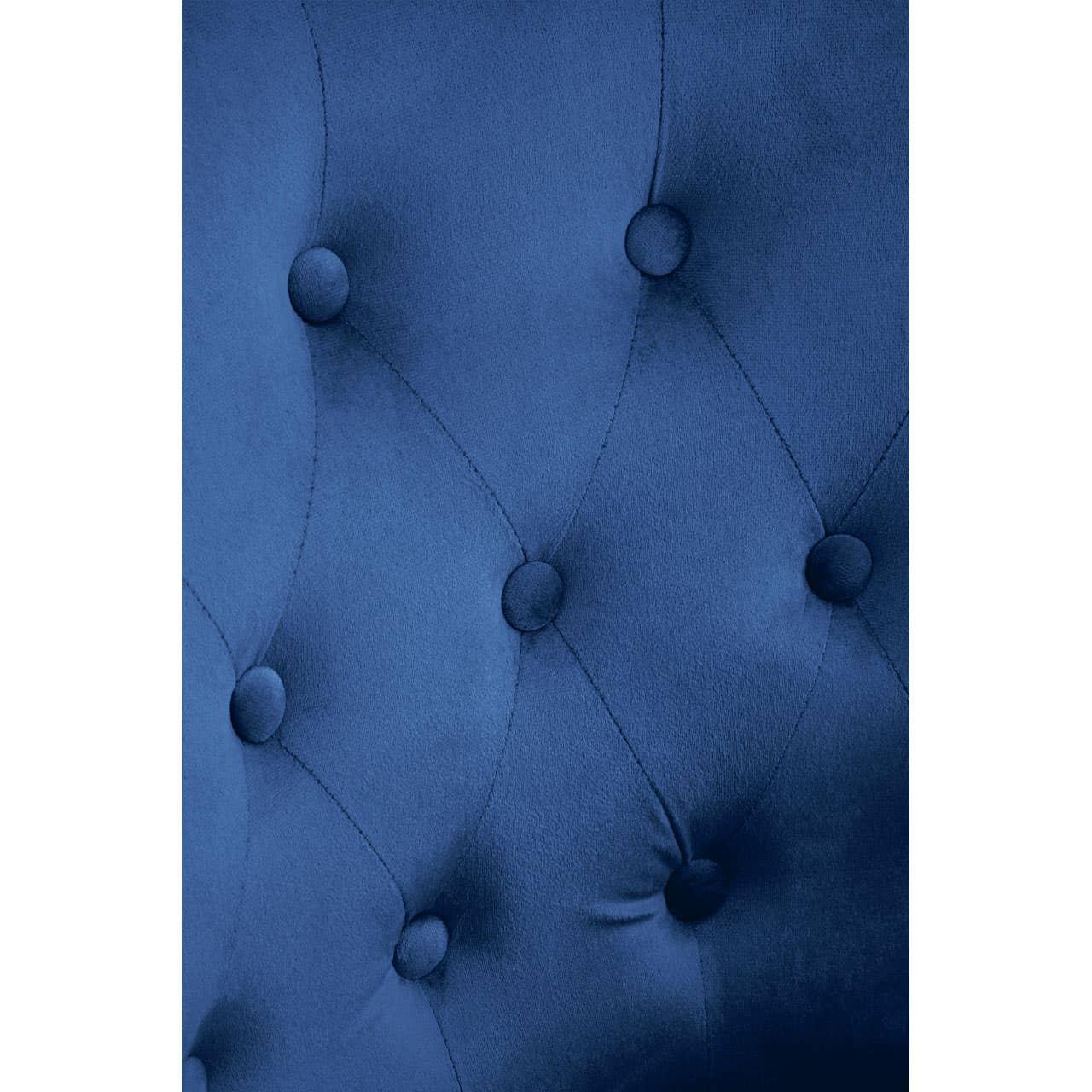Blue velvet upholstered headboard with deep button tufting close-up