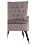 Taupe velvet accent chair with button backrest and tapered black legs with gold tips
