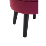 Round wine-colored velvet stool with a plush top and four black wooden legs. The legs are tapered and provide a modern contrast to the soft fabric of the seat