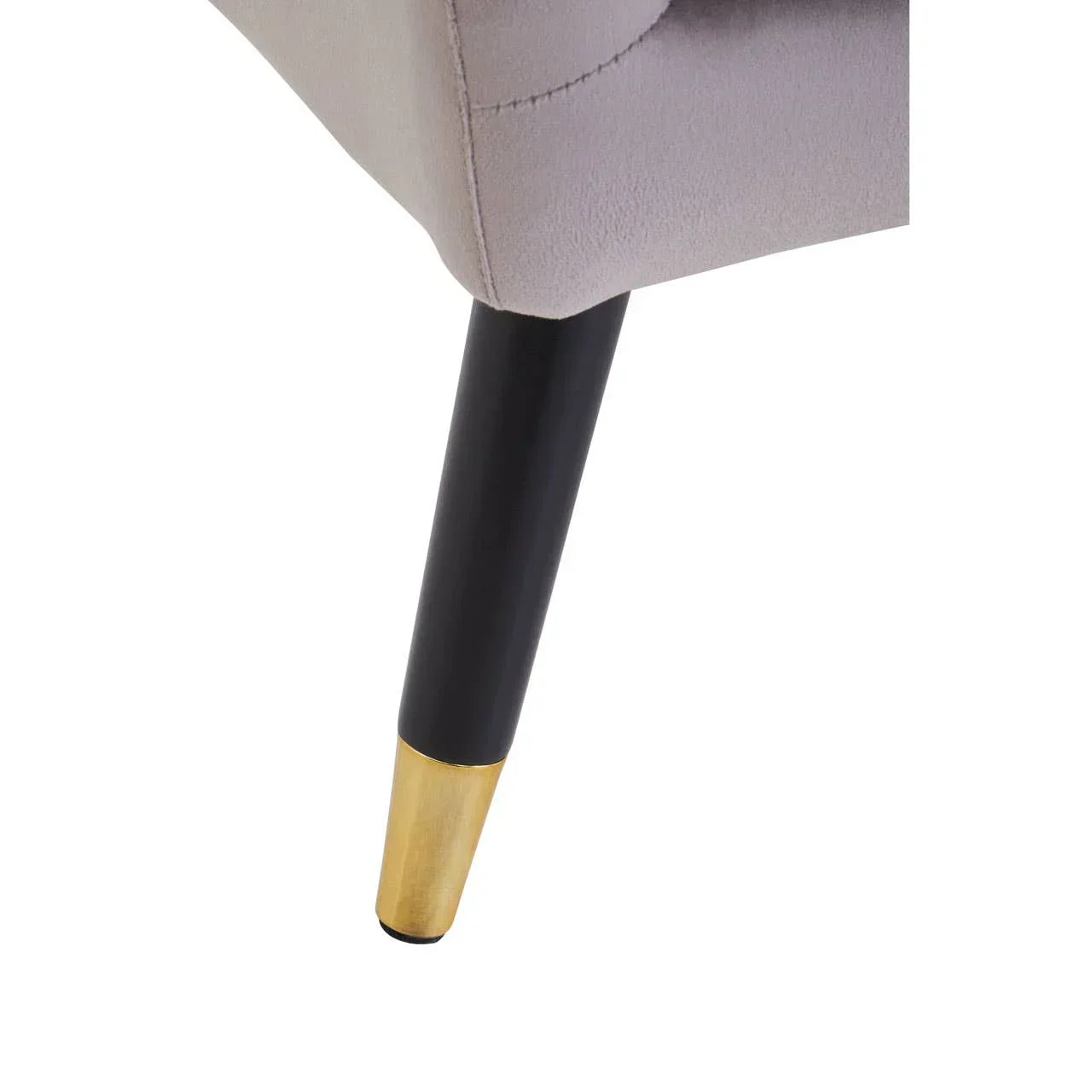 fabric armchair leg with black and gold metal base closeup