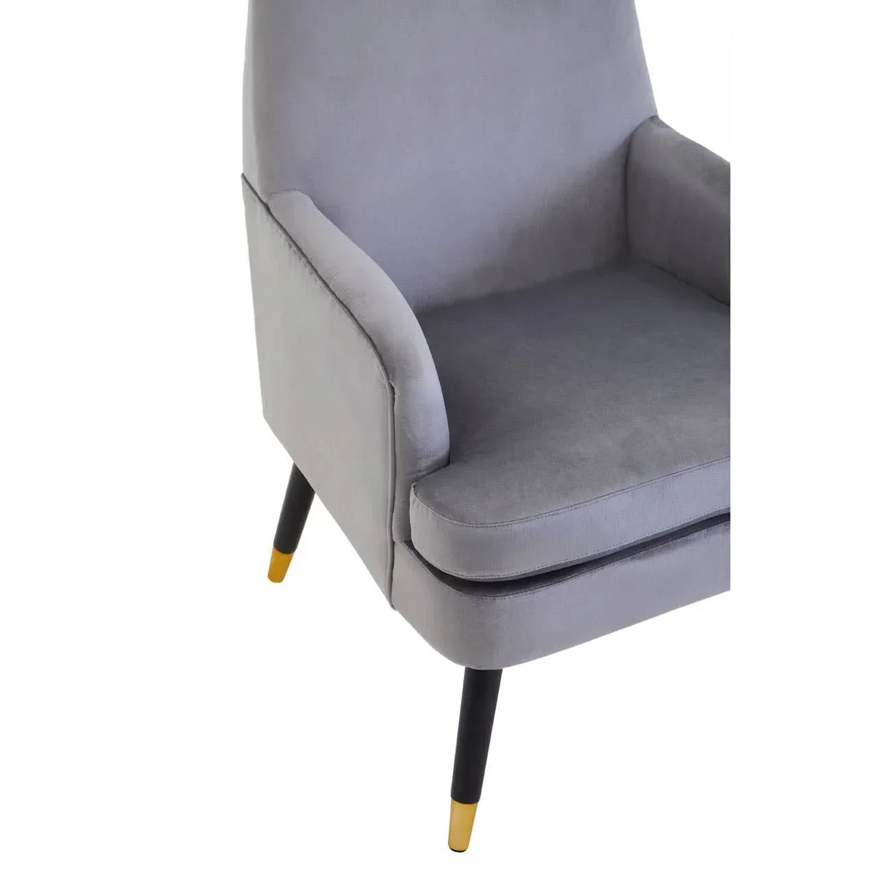 Grey armchair with soft upholstery, angled armrests and black legs with gold tips