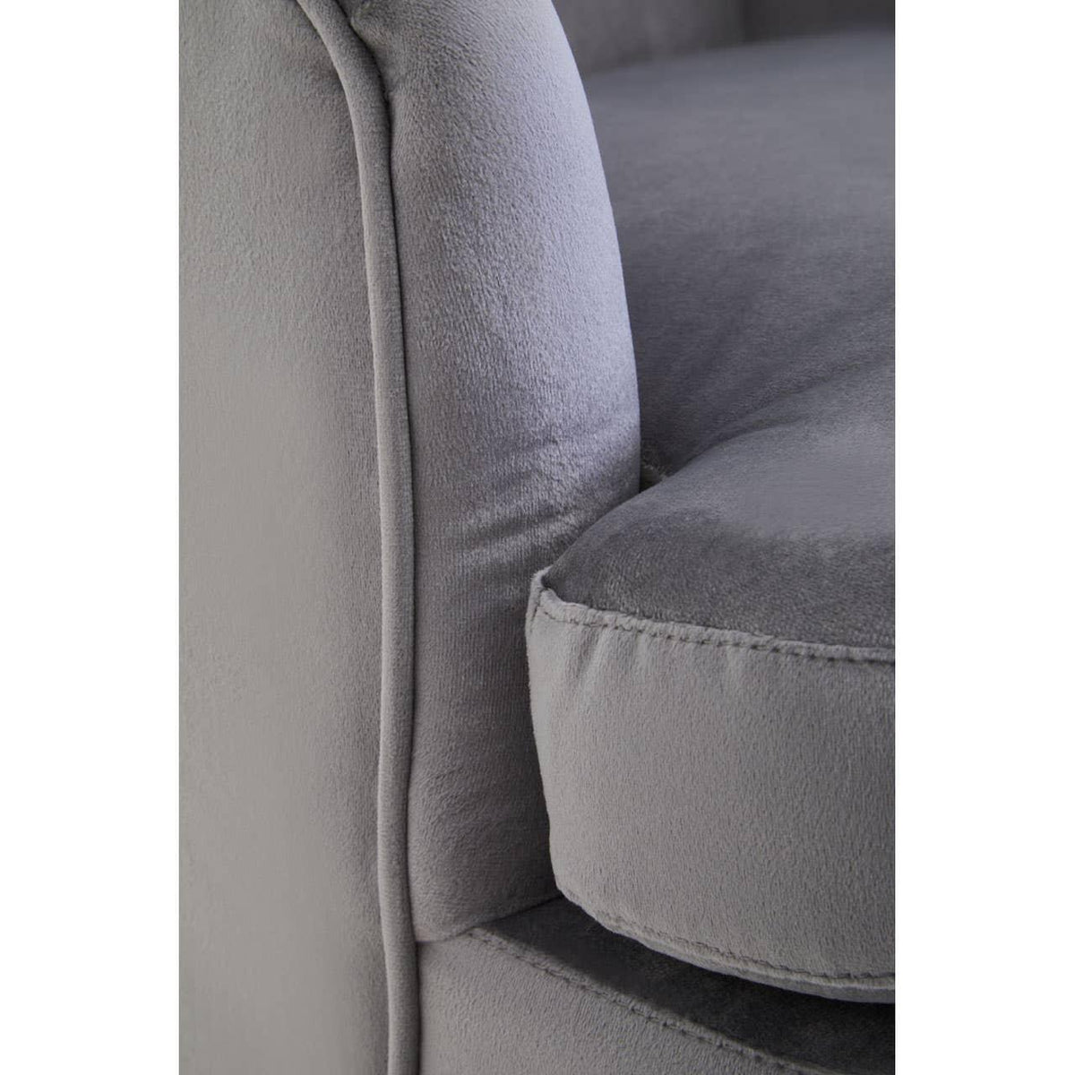 Close up of grey fabric sofa arm and cushion showing stitched edge detail