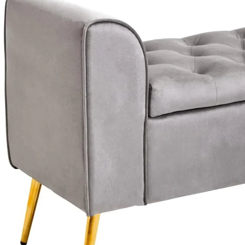 Grey velvet sofa bench with tufted seat and gold metal legs, side angle view