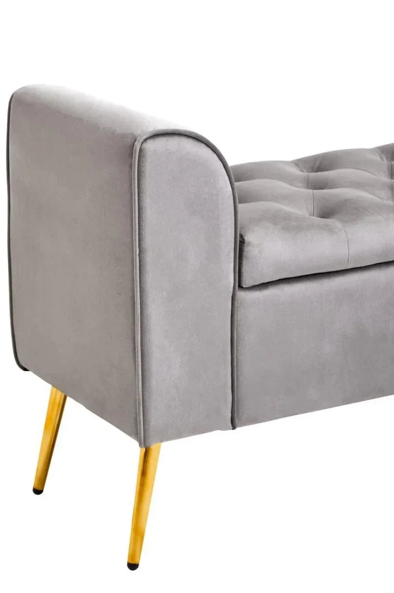 Grey velvet sofa bench with tufted seat and gold metal legs, side angle view