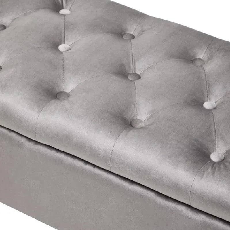 Grey velvet ottoman bench with tufted button detail, close view of cushioned top