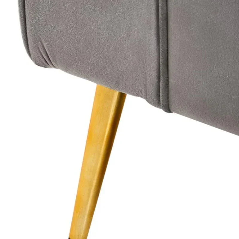 Grey upholstered sofa corner with angled wooden leg, close-up detail view