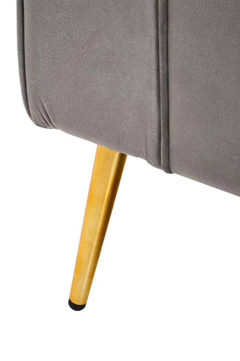 Grey upholstered sofa corner with angled wooden leg, close-up detail view
