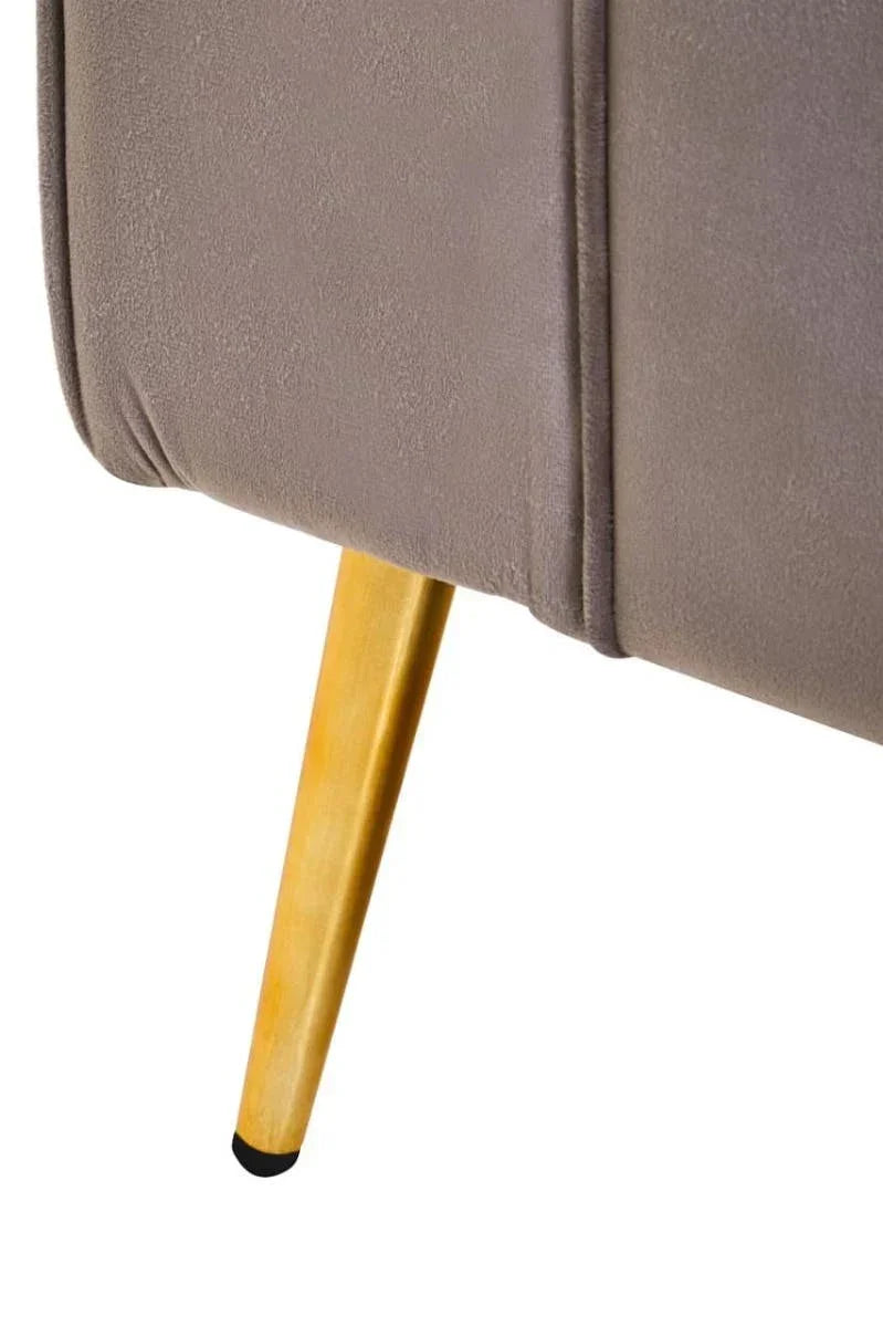 Close-up of grey upholstered sofa corner with wooden tapered leg