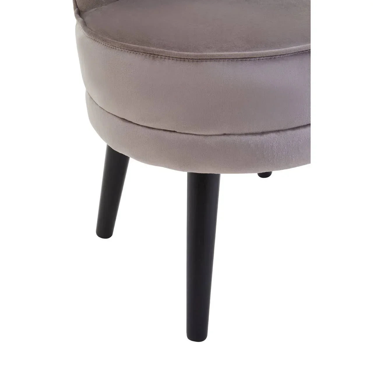 Closeup of grey velvet chair seat with black wooden legs, modern furniture detail
