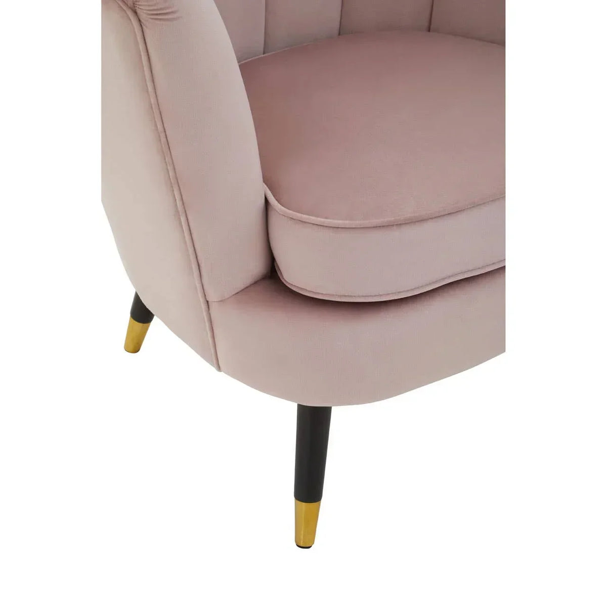 Blush pink accent chair with plush cushion and gold-tipped black legs, close-up view