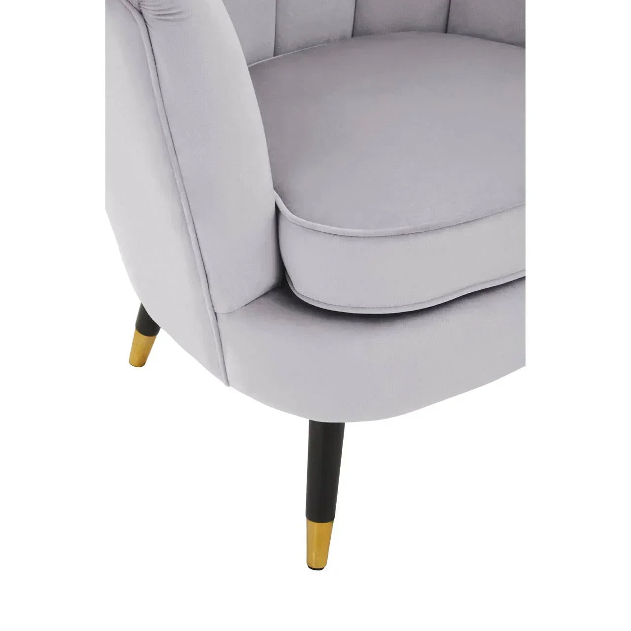 Light grey armchair with gold-tipped black legs and plush seat cushion, angled close-up view
