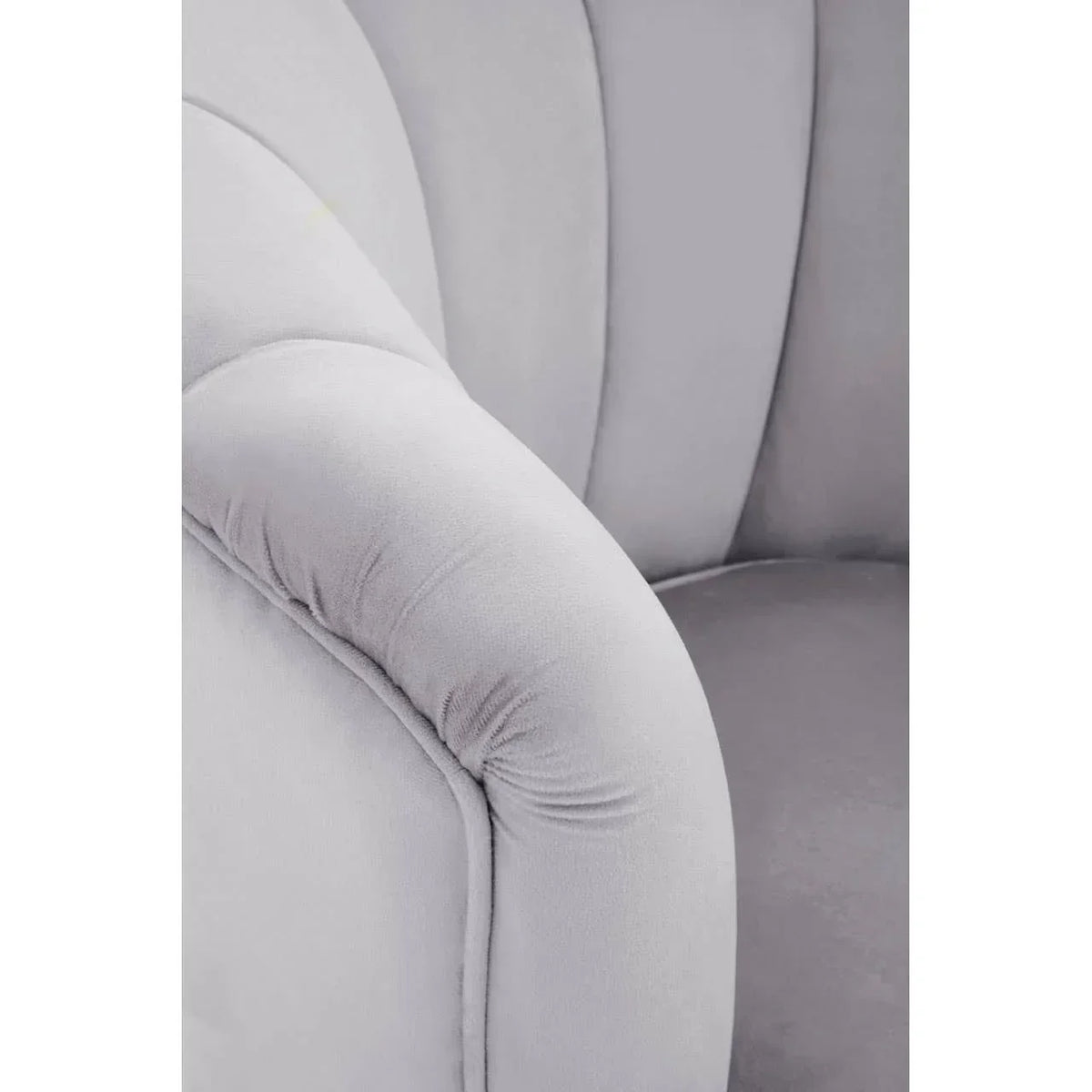 Close up of grey velvet sofa arm and backrest with soft curved detailing