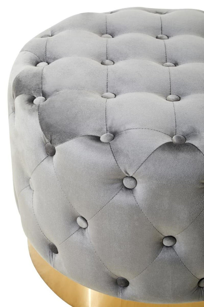 Grey velvet stool featuring a tufted design with buttons and a matte gold finish metal base. The soft upholstery and elegant shape create a stylish accent piece for home decor