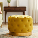 Round velvet stool in a vibrant pistachio color, featuring a tufted design and a matte gold finish base. The stool is placed on a patterned rug with a wooden side table in the background