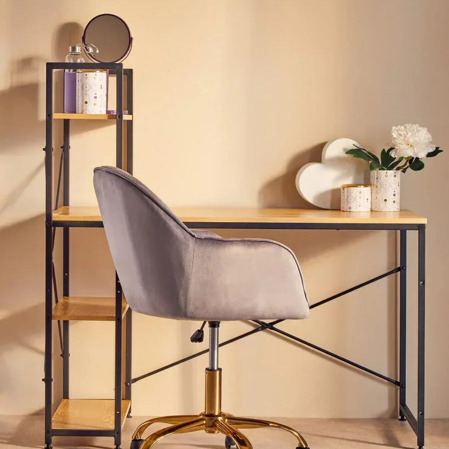 Velvet office chair with gold base at modern wooden desk and metal shelving unit