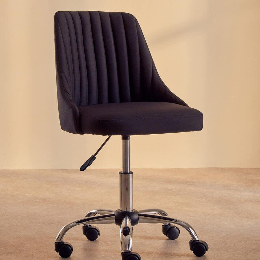 Black swivel office chair with vertical stitching and chrome base on castor wheels