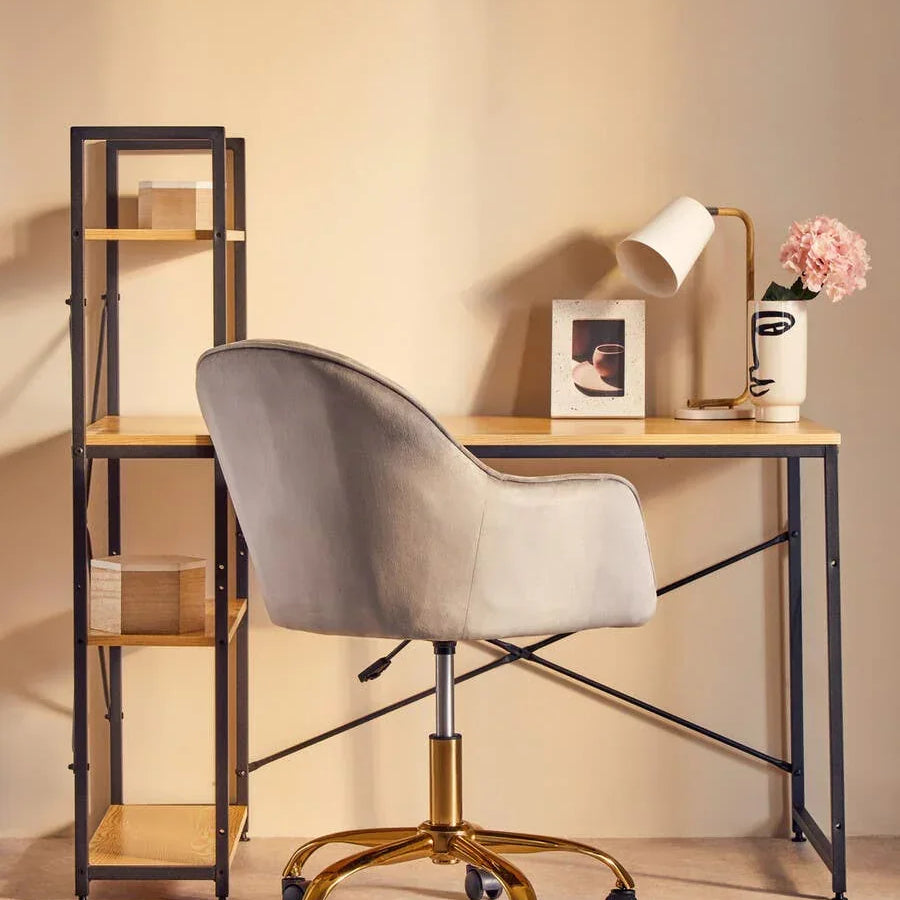 Modern desk with shelving, taupe swivel office chair and lamp in home office setup