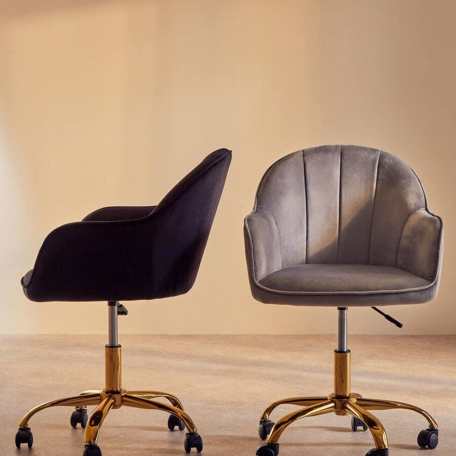 Velvet office chairs with gold swivel bases, one in grey front view, one in black side view