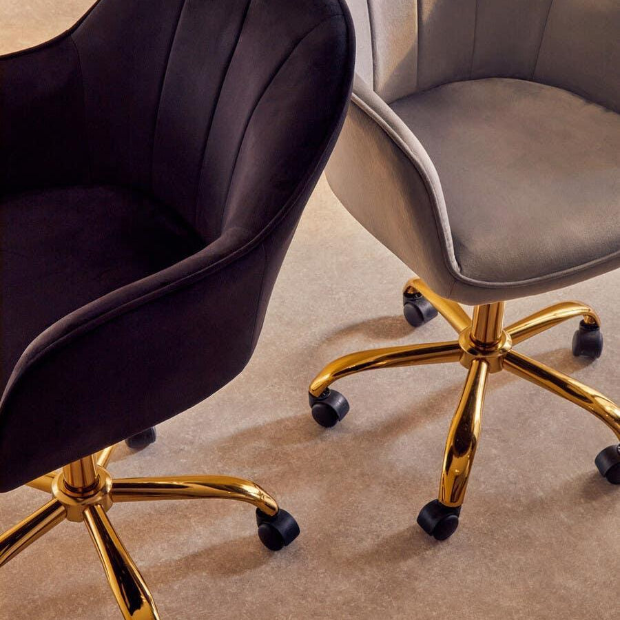 Velvet office chairs with gold swivel bases in black and grey finish, side by side on carpet