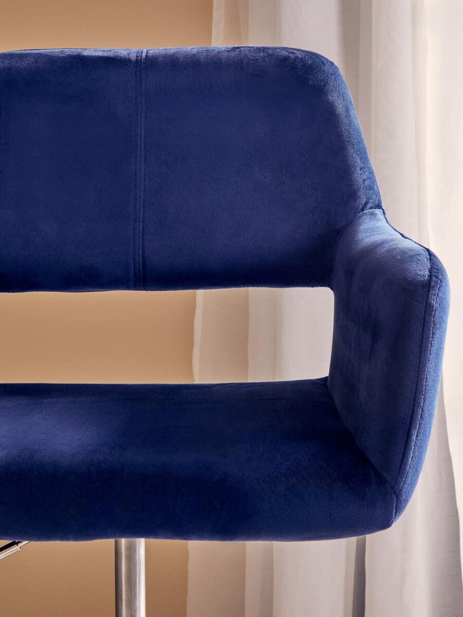 Blue velvet bar stool with metal leg and open backrest near window