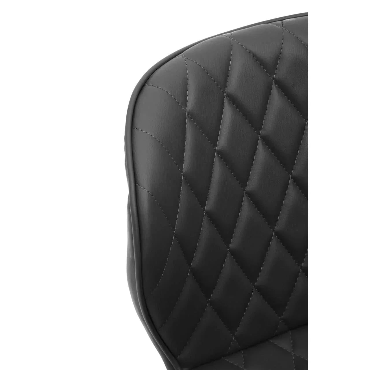 Black faux leather chair backrest with diamond quilted stitching detail