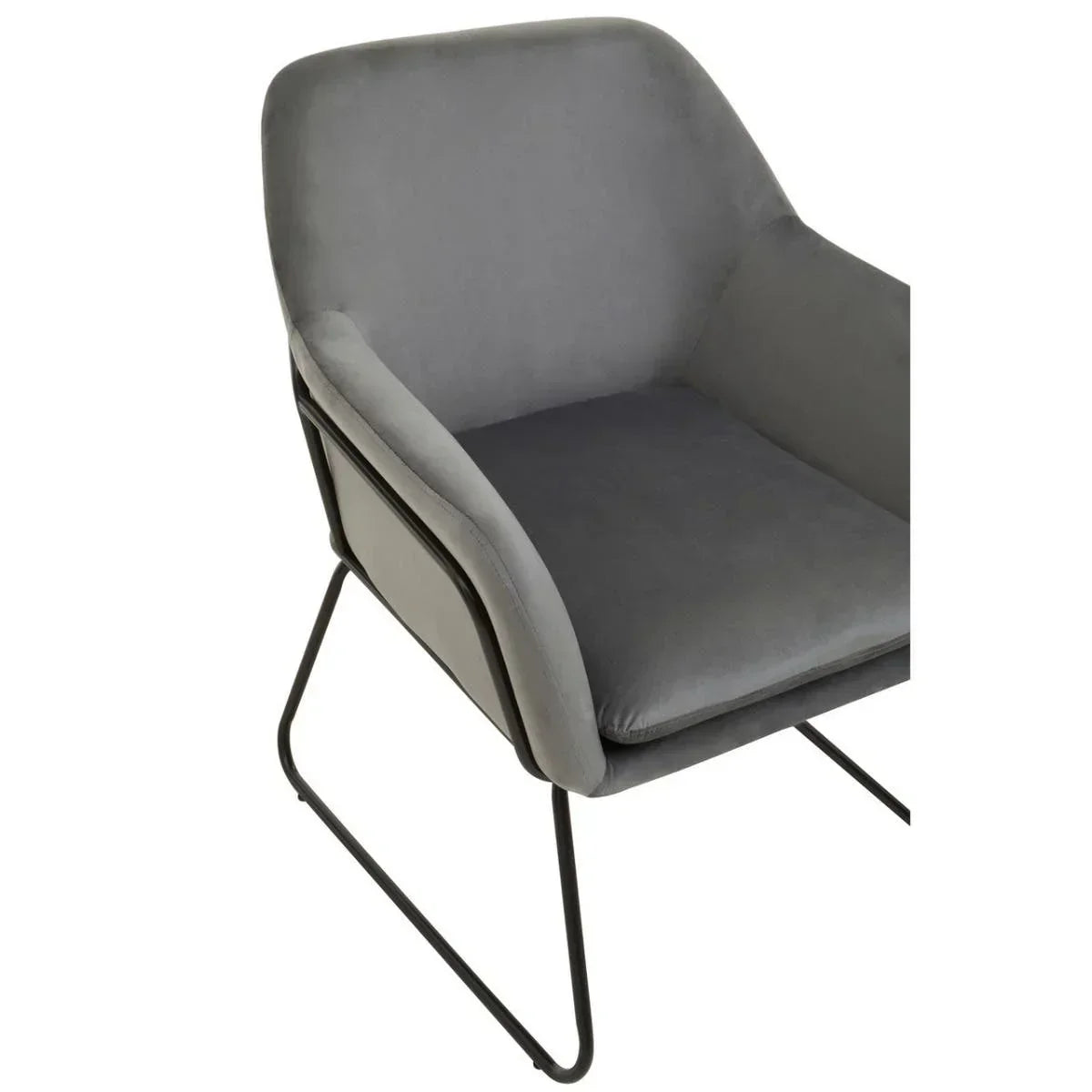 Grey velvet dining chair with black metal legs and armrests, angled front view