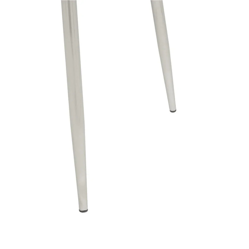 Close-up of metal chair legs with polished chrome finish on white background