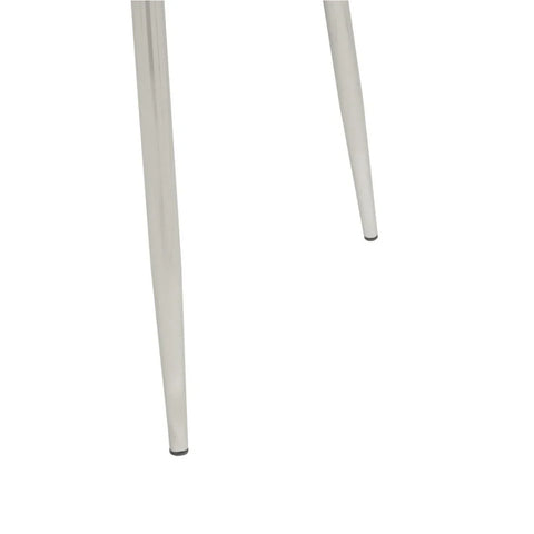 Close-up of metal chair legs with polished chrome finish on white background