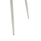 Close-up of metal chair legs with polished chrome finish on white background