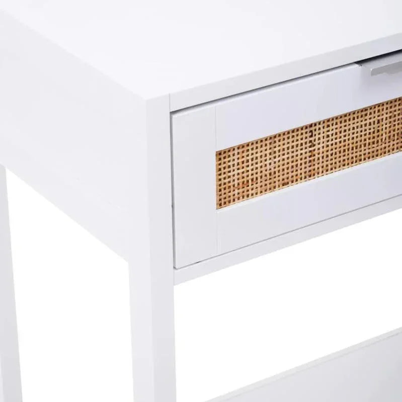 White console table with single drawer and rattan panel detail, side angle view