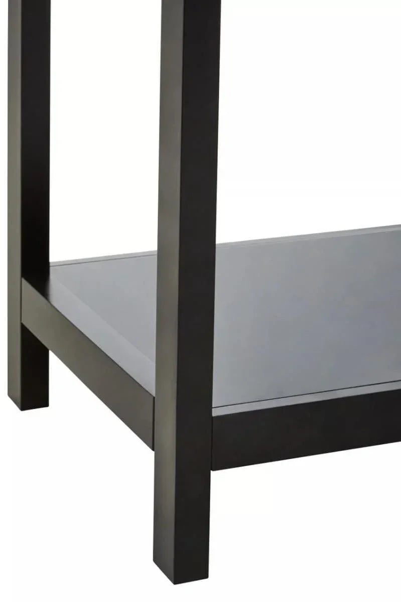 Close view of black wooden table leg with lower shelf