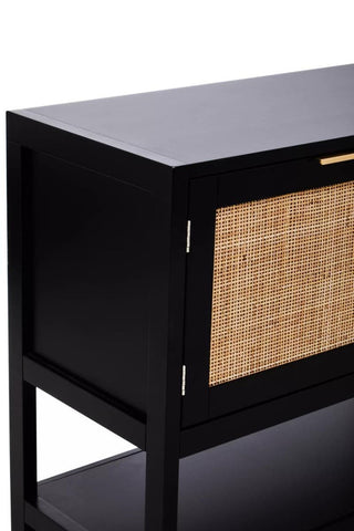 Black wood side cabinet featuring two doors with rattan panels, a sleek top surface, and an open shelf below. The cabinet has a modern design with clean lines and a minimalist aesthetic