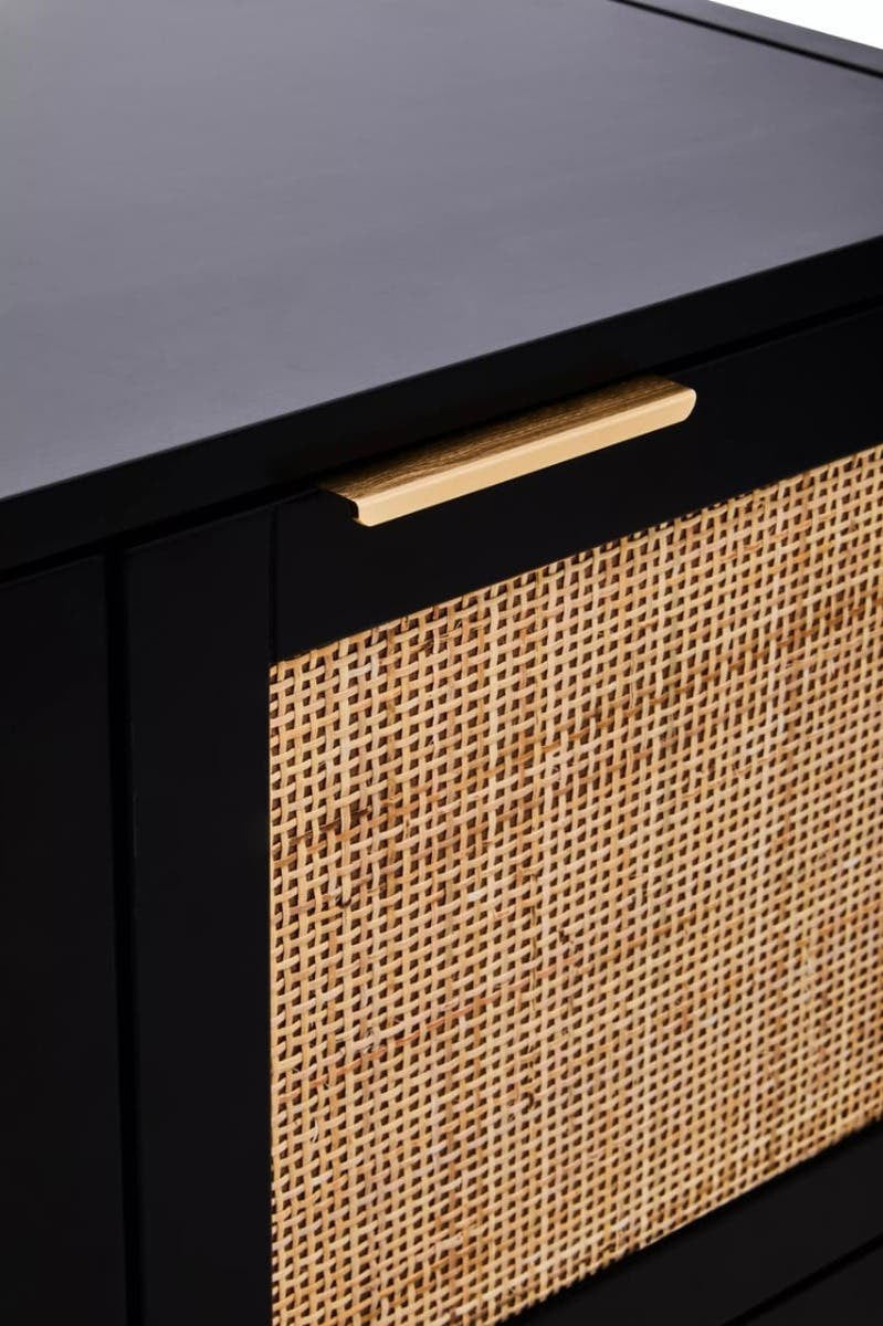 Black wood side cabinet featuring two doors with woven rattan panels and a sleek gold handle. The cabinet has a smooth top surface, ideal for decorative items or storage