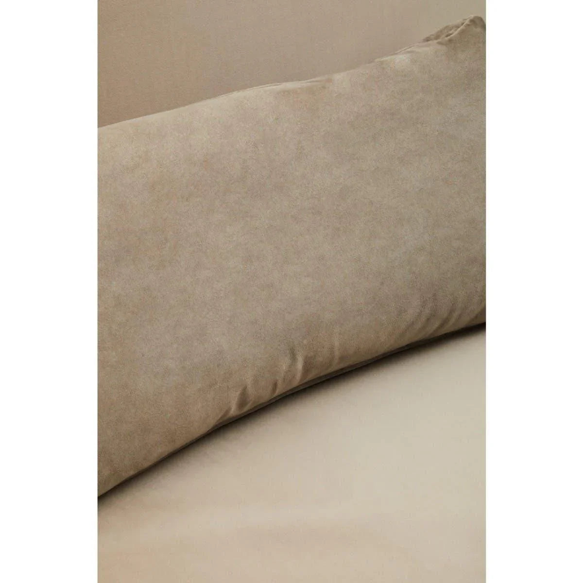 Beige sofa cushion in soft fabric closeup on matching seat and backrest
