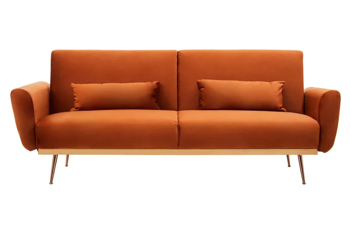 Modern orange velvet sofa with gold legs and matching cushions, front view on white background
