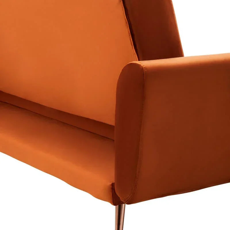 Rust orange fabric sofa with slim metal legs shown from rear side angle