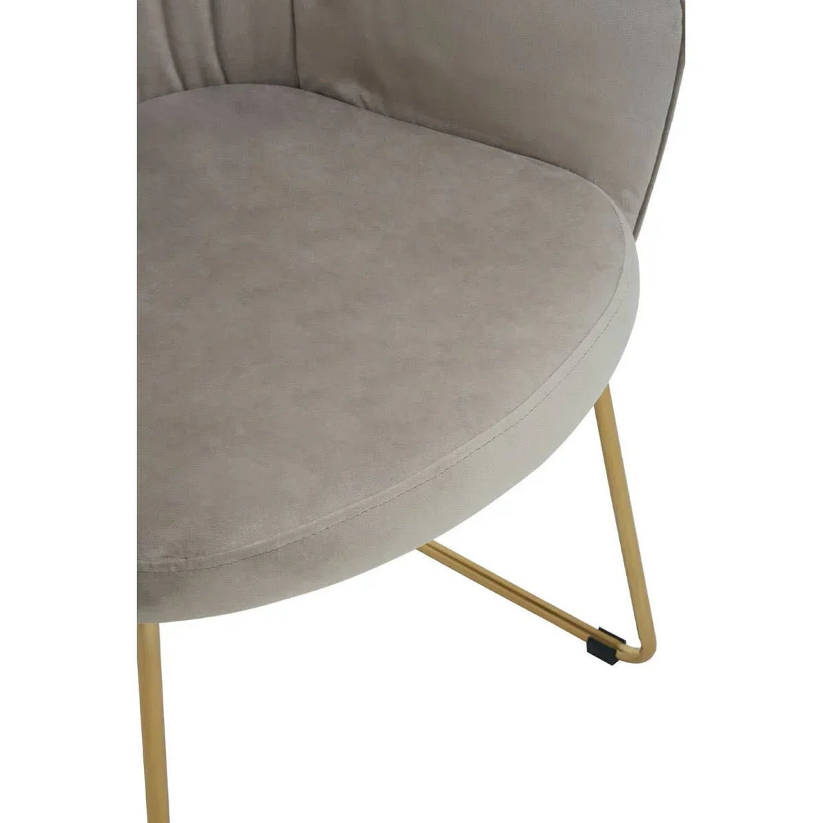 Beige accent chair seat with curved backrest and gold metal legs, close-up view