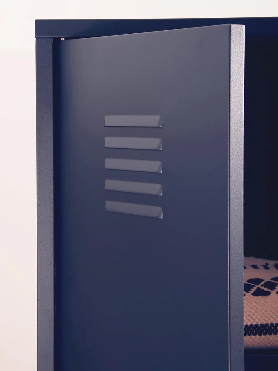 Close-up of navy metal locker cabinet door partially open with vent detail