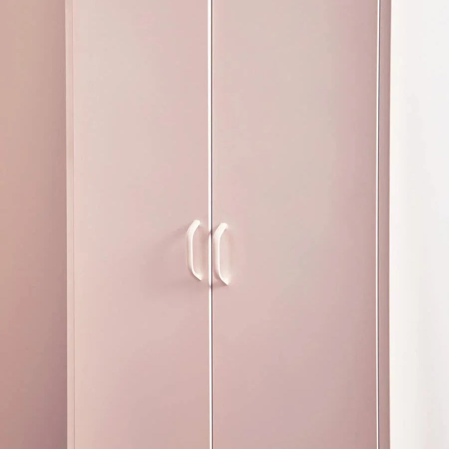 Pink wardrobe with double doors and white handles against a light wall