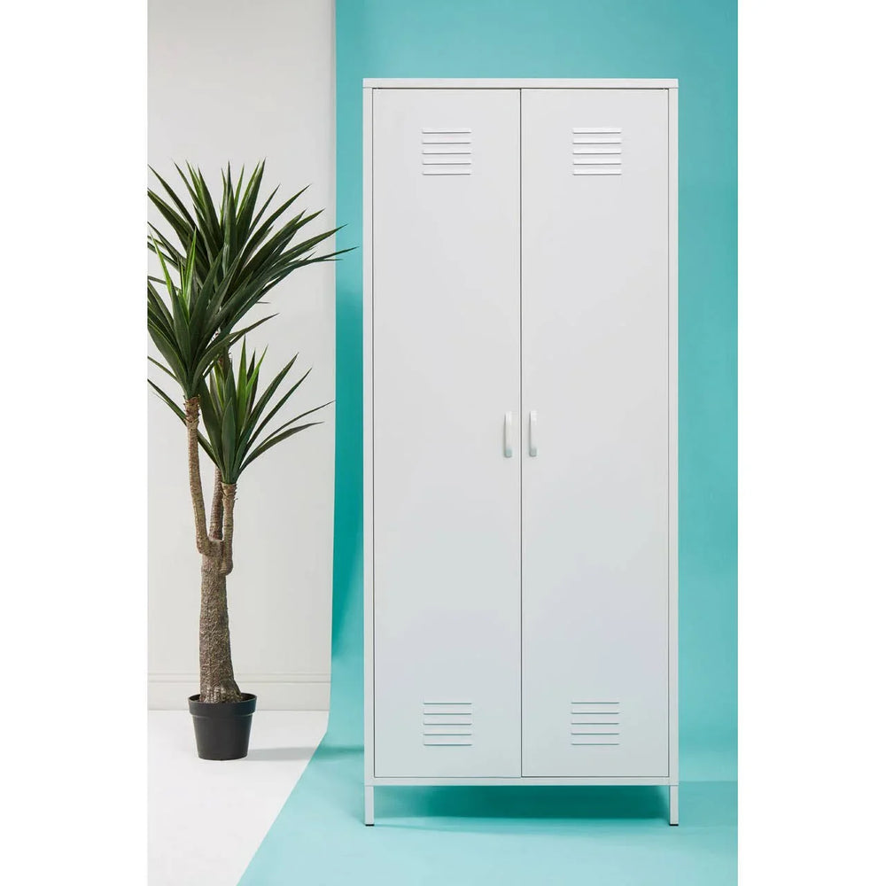 White metal storage cupboard with double doors and handles, set beside a potted plant