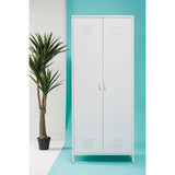 White metal storage cupboard with double doors and handles, set beside a potted plant