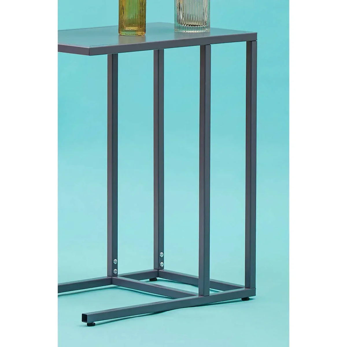 Metal side table with black frame and rectangular top, shown against a blue background