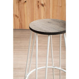Bar stool featuring a round wooden seat with a light wood finish and a sleek white metal frame with four slender legs, set against a backdrop of wooden panels