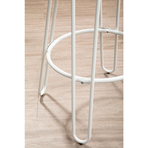 White metal frame of a bar stool featuring slender legs and a circular footrest, set against a light wooden floor