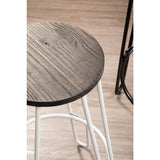 A close-up view of a bar stool featuring a round wooden seat with a rustic finish and a white metal frame. The stool is positioned on a light-colored wooden floor, highlighting its modern design and contrasting materials
