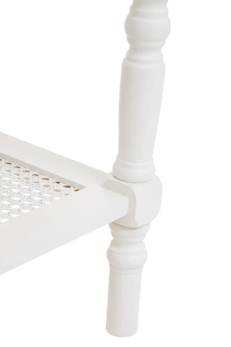 White wooden furniture leg with turned design and woven rattan shelf detail